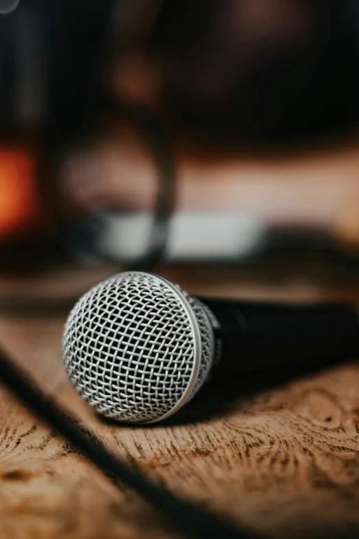 a microphone resting on top of a wooden desk