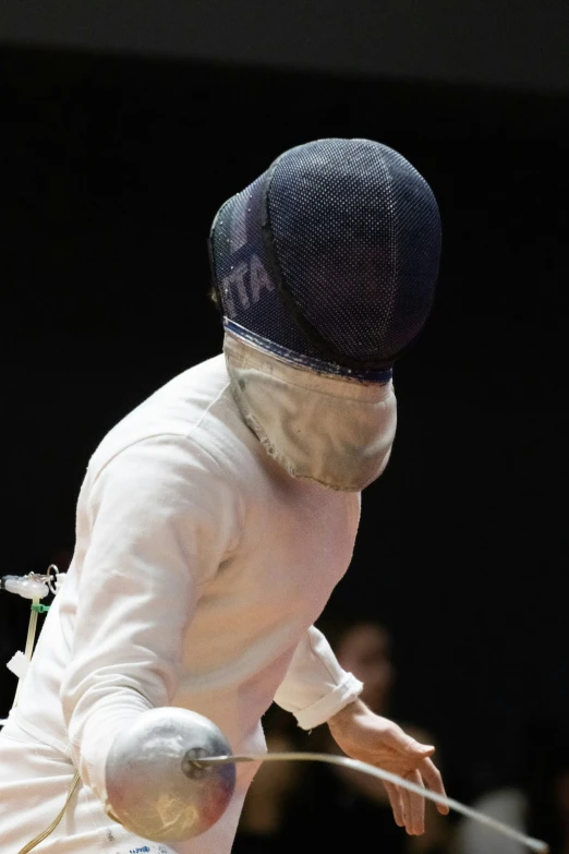 a man on a fencing board hitting the ball