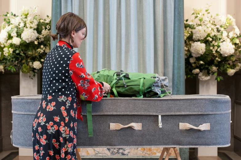 a woman is pulling luggage from the floor