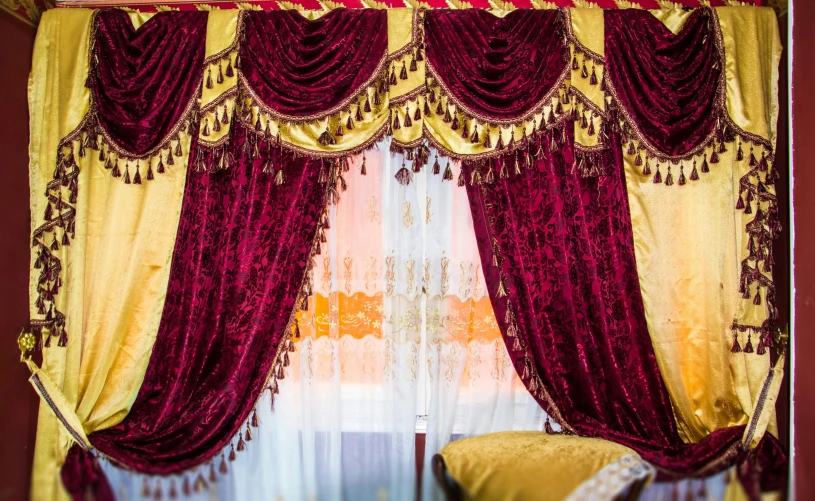 the curtains are adorned in a red and yellow color