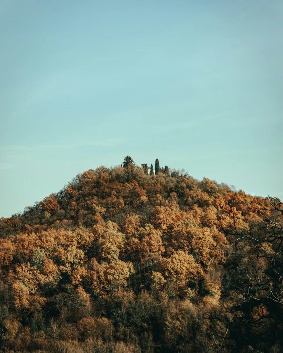 a small mountain with two people standing on it