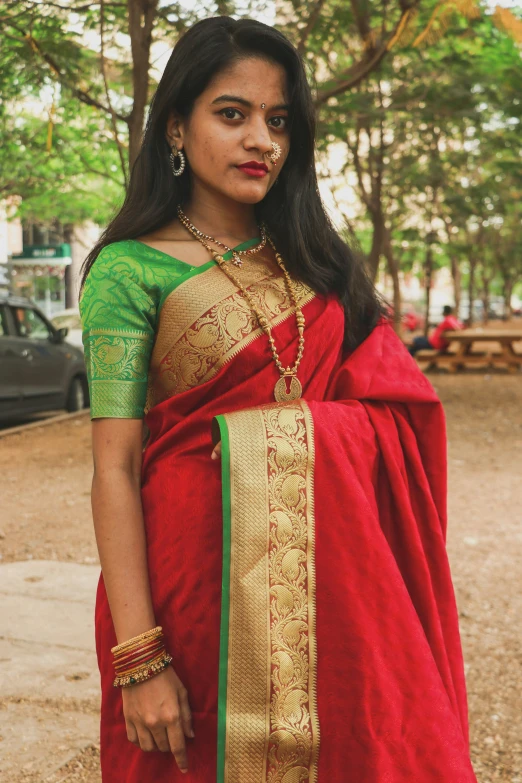 a woman with a necklace wearing a red and green dress