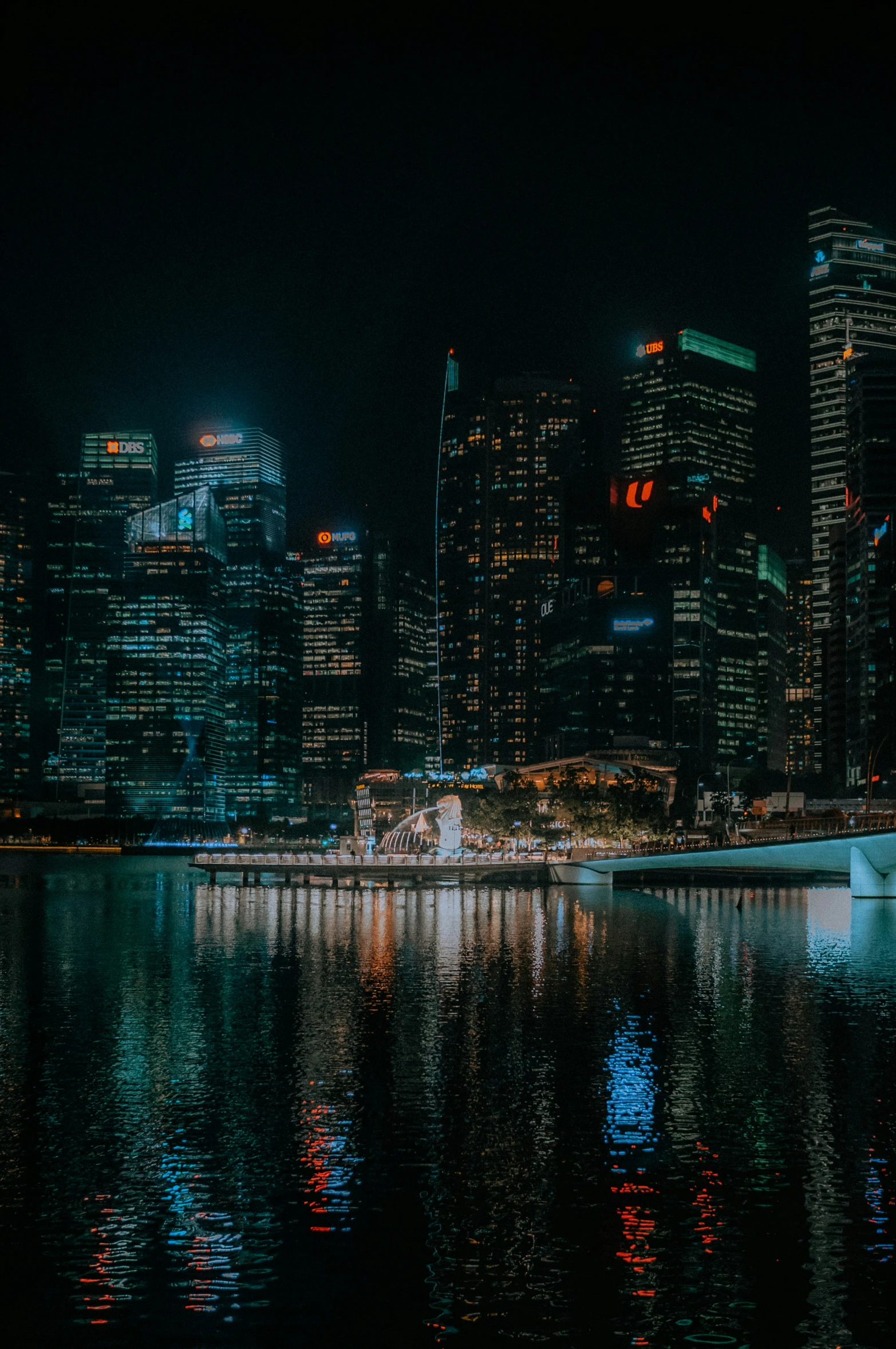 a nighttime skyline and some lights reflecting in the water