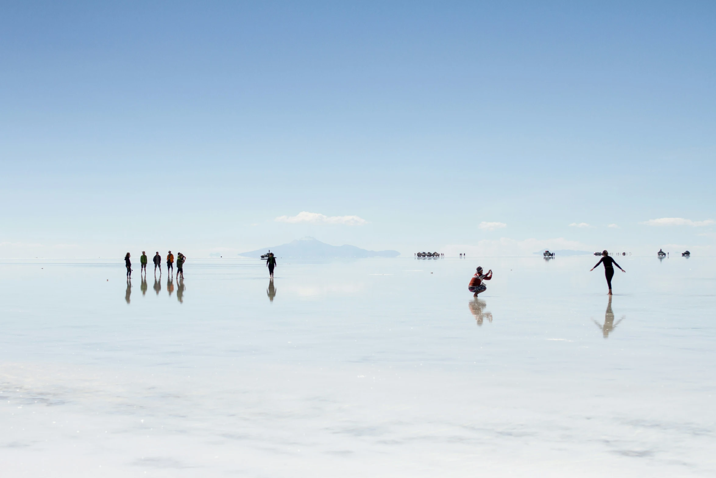 many people are on the beach and water