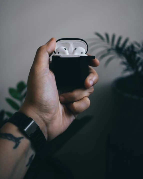 a man holds up an electronic device in his hand