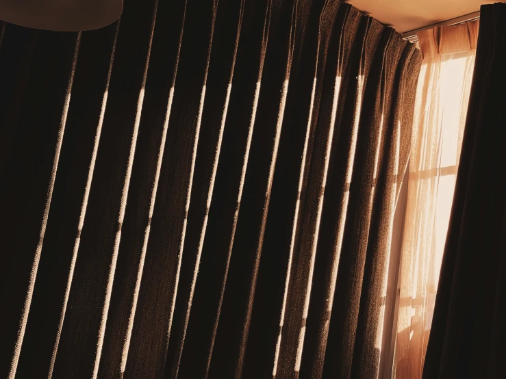 a curtain sitting on top of a wooden window