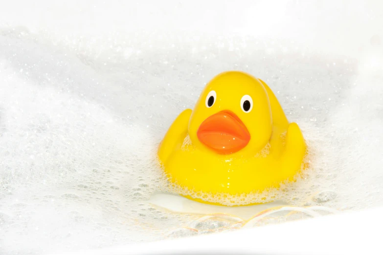 a rubber ducky floating on foam in water