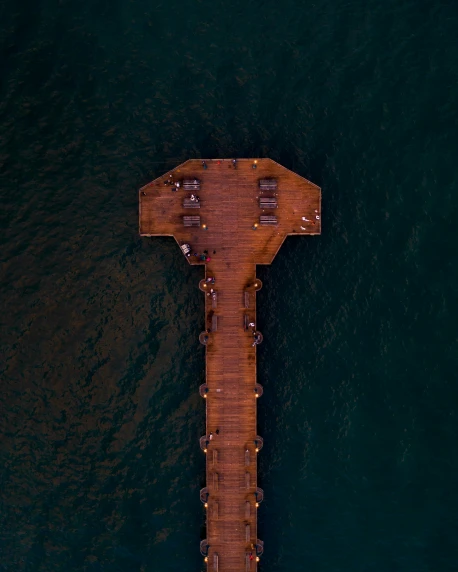 a long pier is in the middle of a river