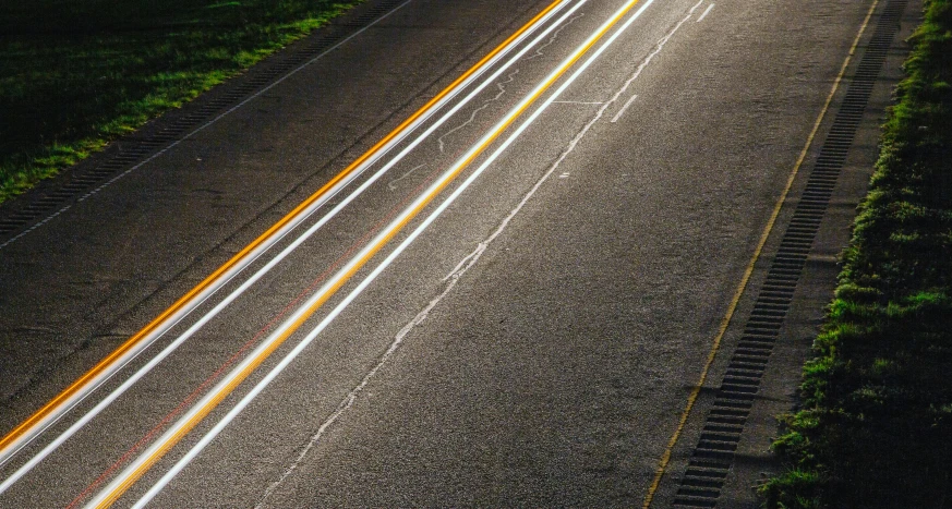 the aerial view of an empty road at night