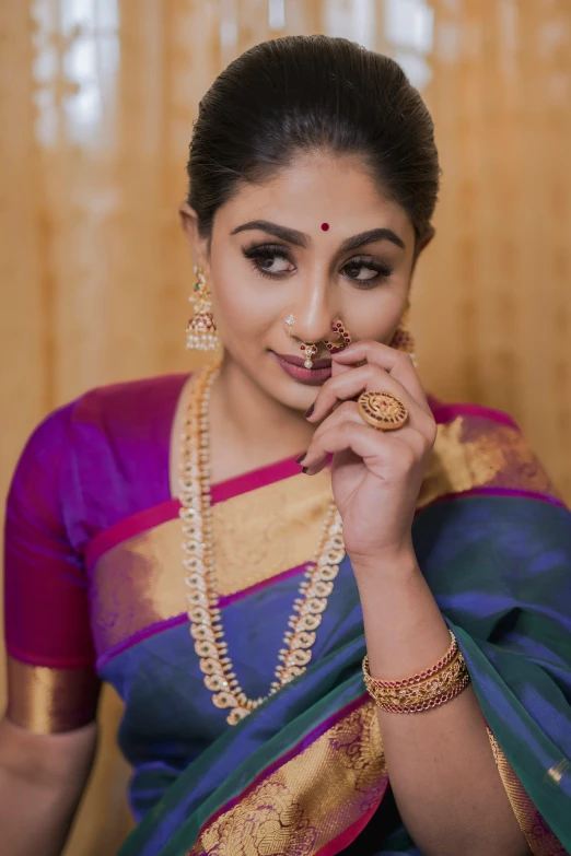 an indian woman dressed in traditional clothing poses for the camera