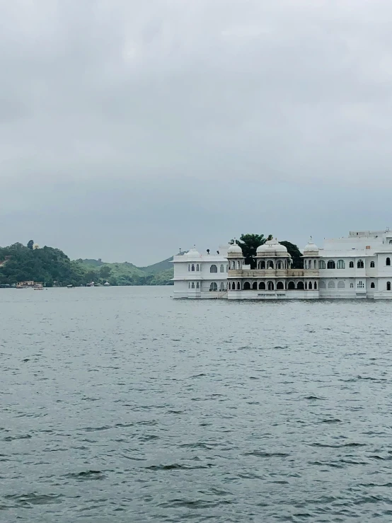 a big white building that is floating in the water