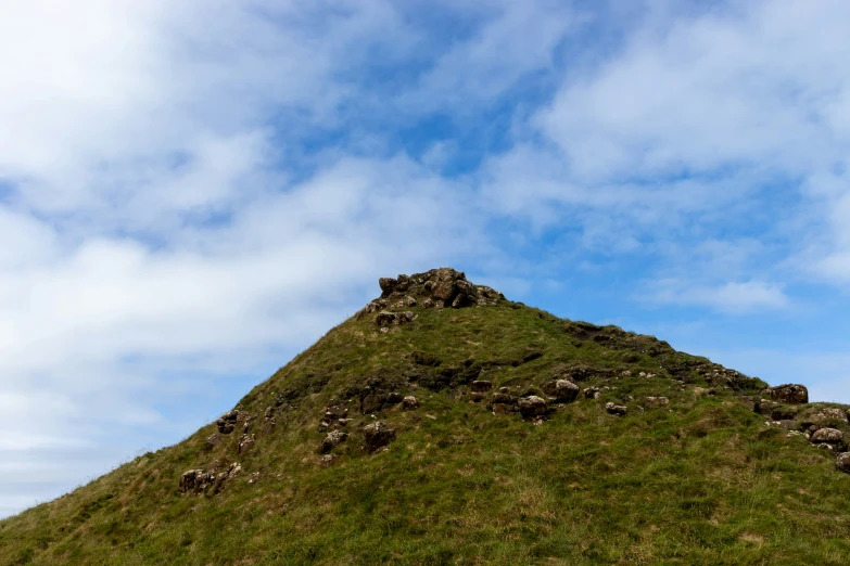 a large hill with no one on it under a blue sky