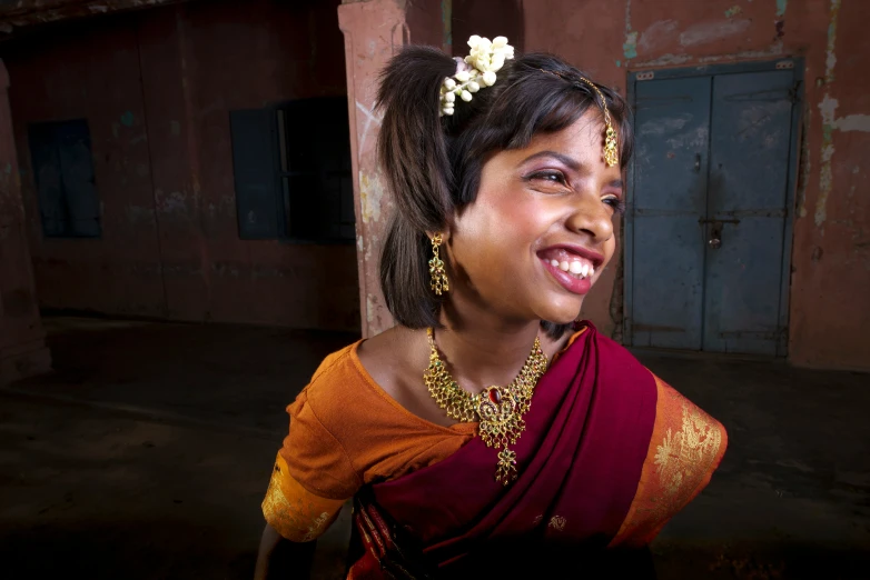 a woman with a flower in her hair is smiling