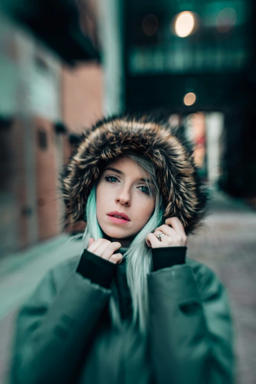 a woman in winter clothing wearing a hood