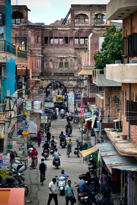 a busy street with people on motorcycles and cars