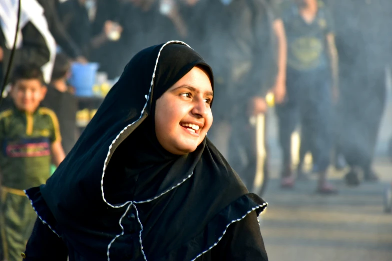 a woman with a veil standing next to a bunch of people