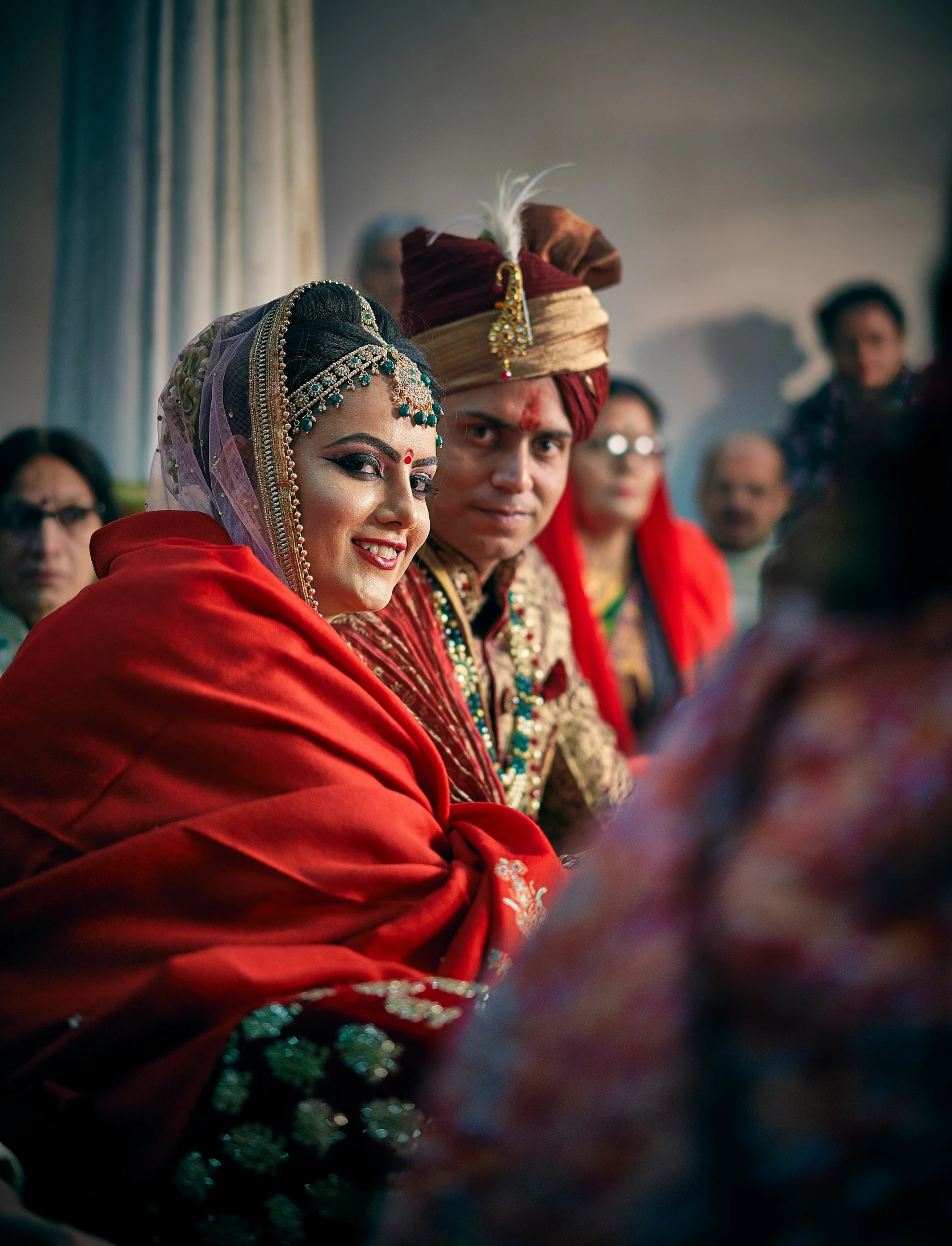 the bride in a sari smiles for the wedding guests