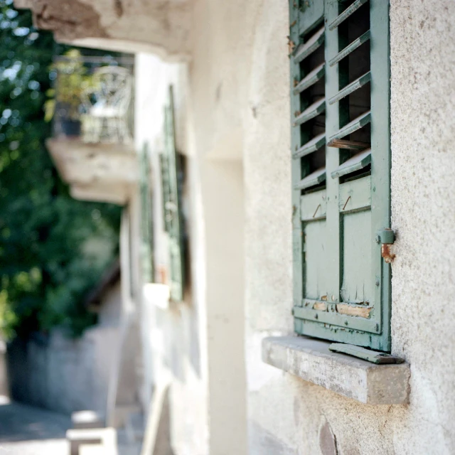 an old building with a window and some chairs