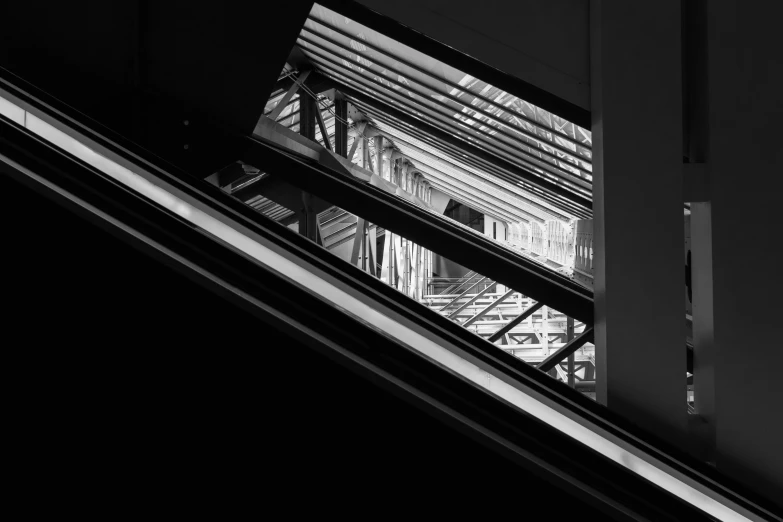 an escalator and window above a stairwell in a building