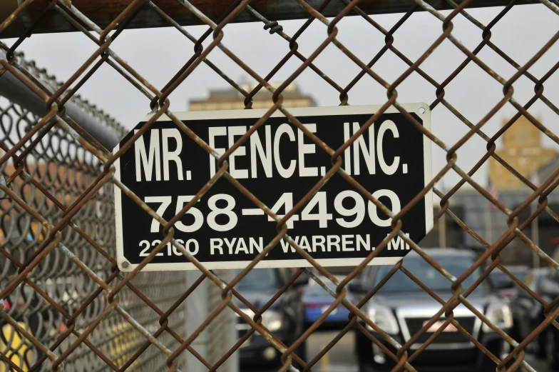 a fence with a sign for a parking lot