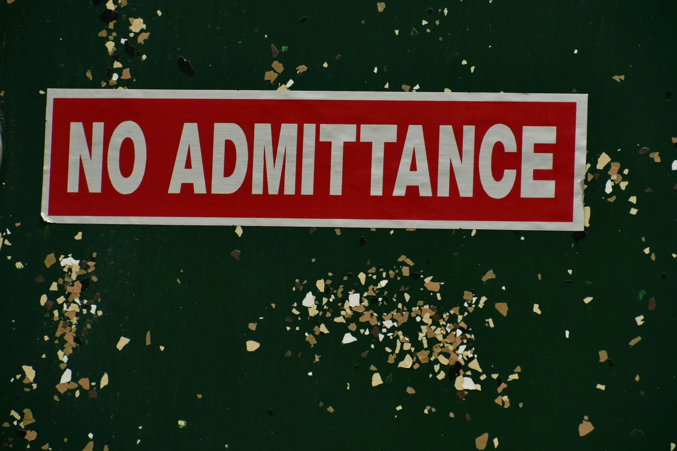 an image of a red and white sticker on the side of a wall