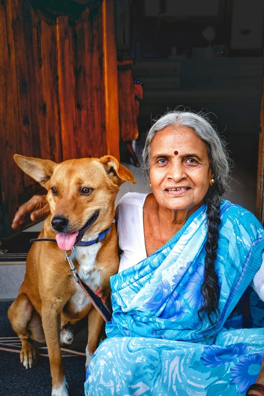 a dog sitting in the front door of a woman's house