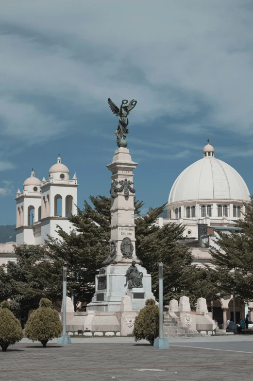 the statue is in front of a large church