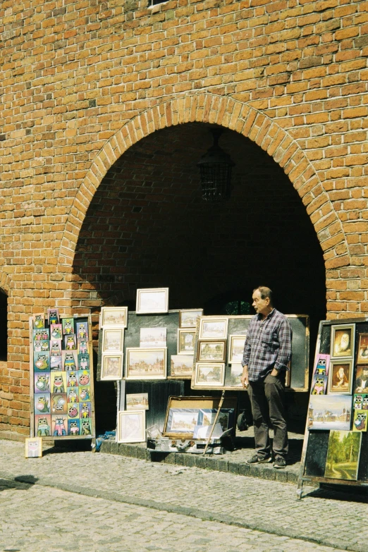 a man standing in front of a display near an arch