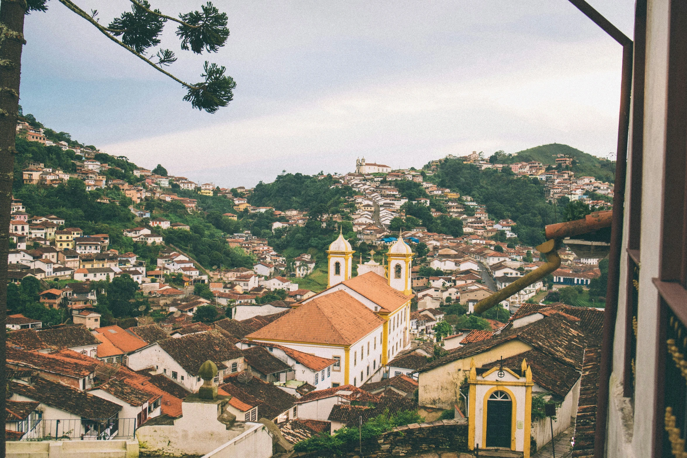 a city sitting on top of a hillside covered in grass