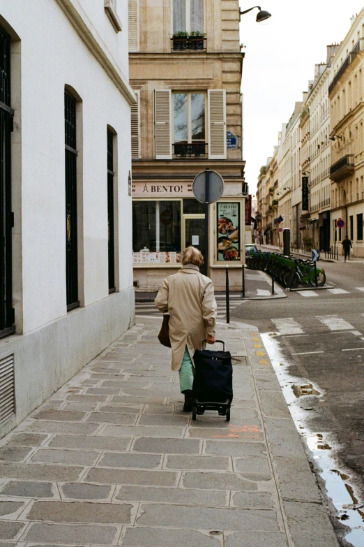 a man walking down the street with a suitcase