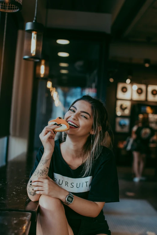 a beautiful woman eating some food in a restaurant