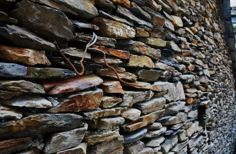 there is a bunch of stone and metal that are on the wall
