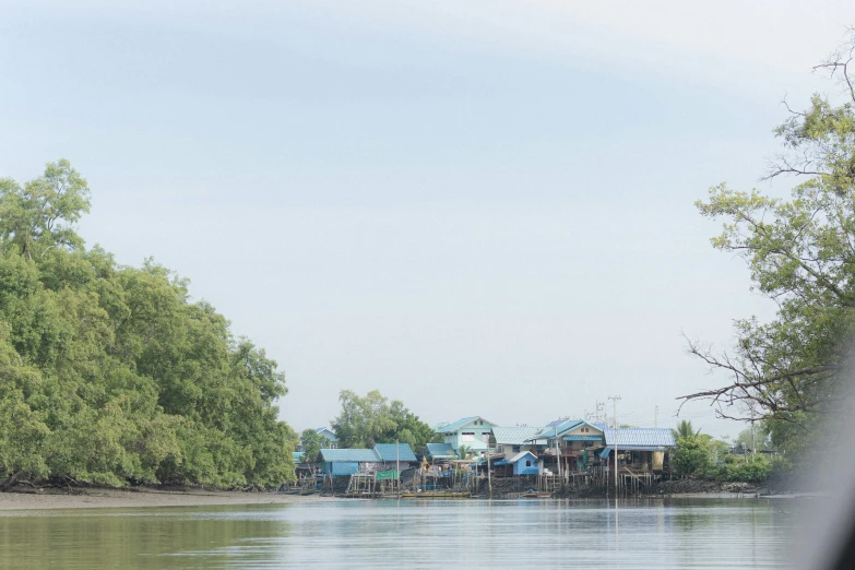 a boat on the water near some shacks