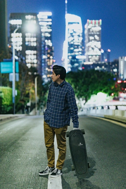 a man on a skateboard standing with his luggage