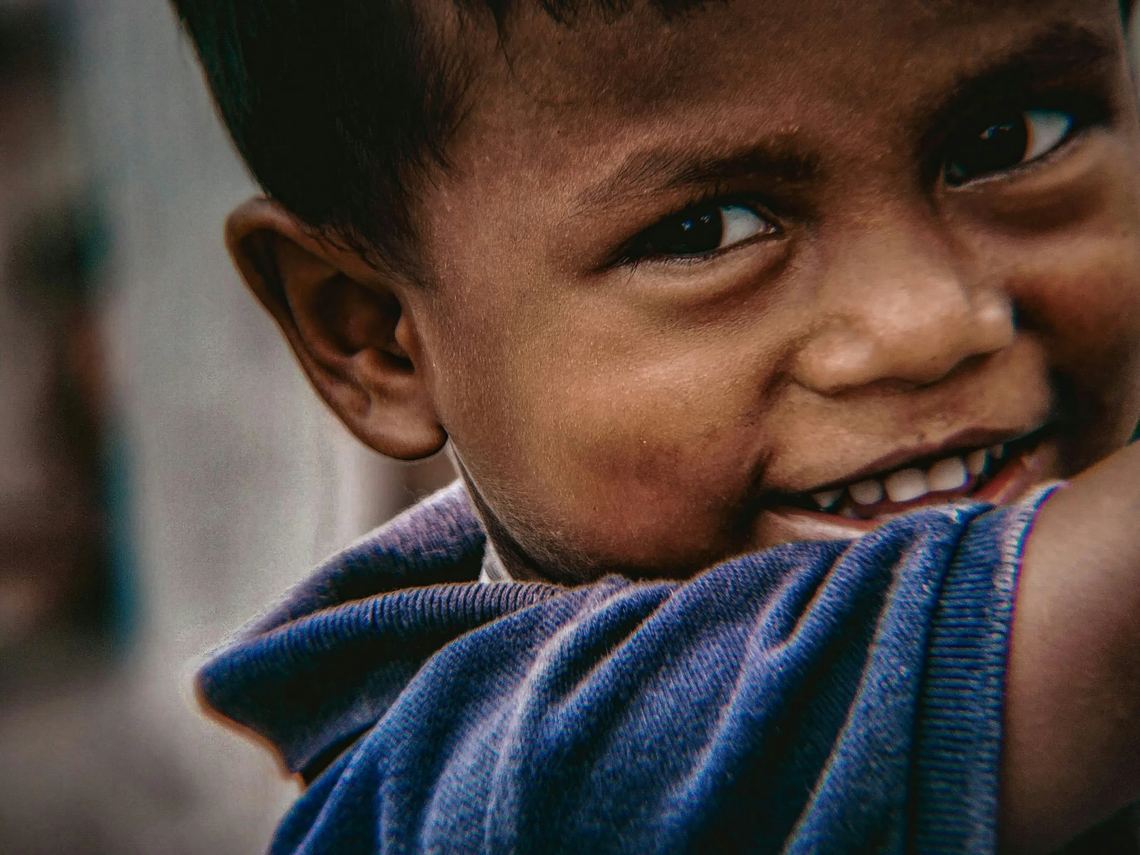 a  smiles and holds his hand on the shoulder of another child