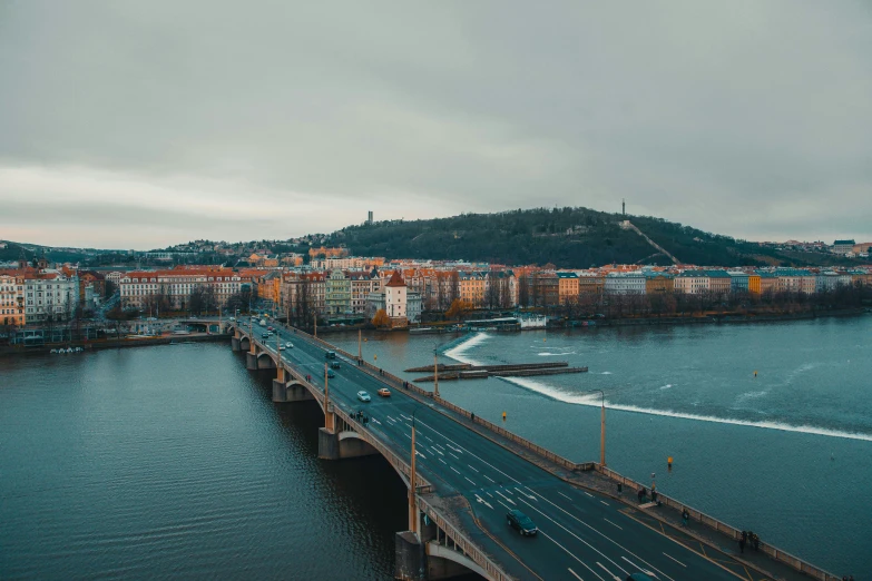 bridge going to a large city on top of the mountain