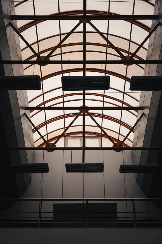 a ceiling in an atrium with an angled glass