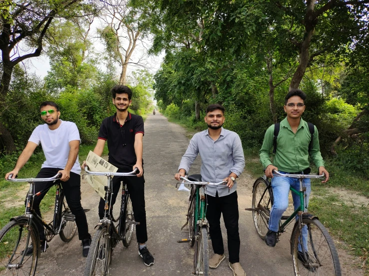 three men on bikes posing for the camera