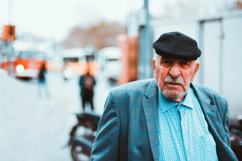 a man walks down the street with an older look on his face