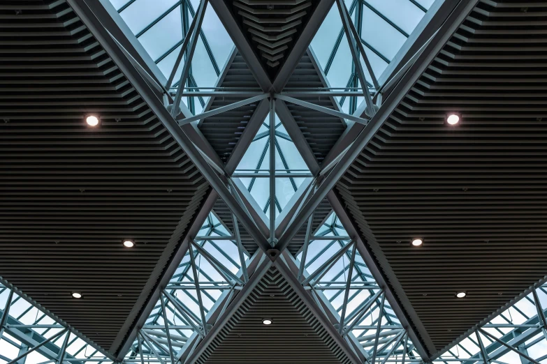 inside the ceiling of an airport with multiple rows of seats