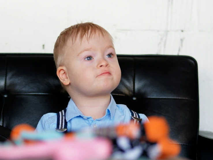 a  sitting on a chair with his eyes open