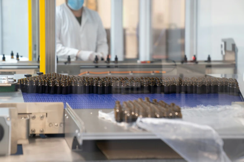 machine making brown bullet shapes in a factory