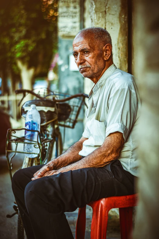 a man is sitting on a red chair