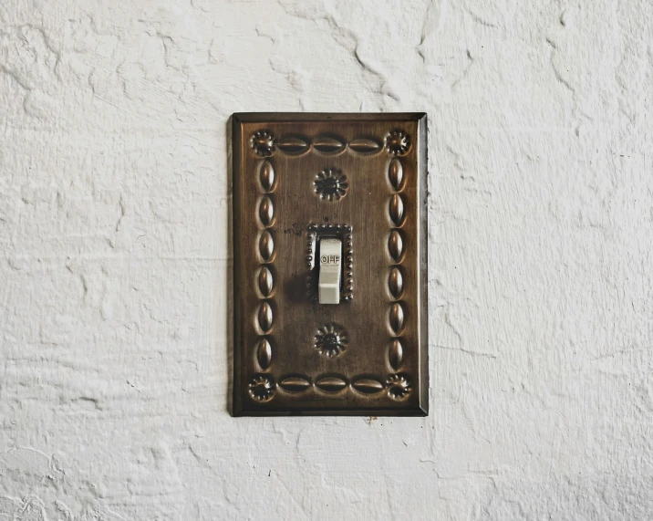 a white wall with a switch and a light switch