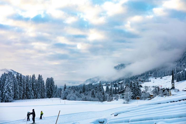 people with skis stand in the snow outside