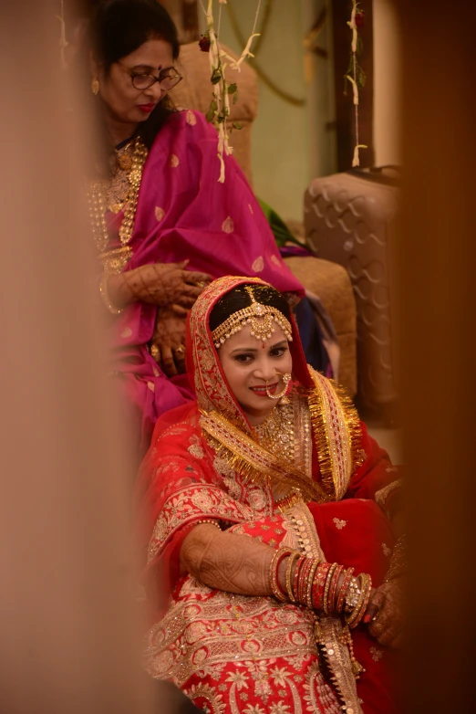 a beautiful indian bride getting ready to take her wedding po