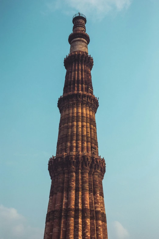 a tall building with two towers, against a blue sky