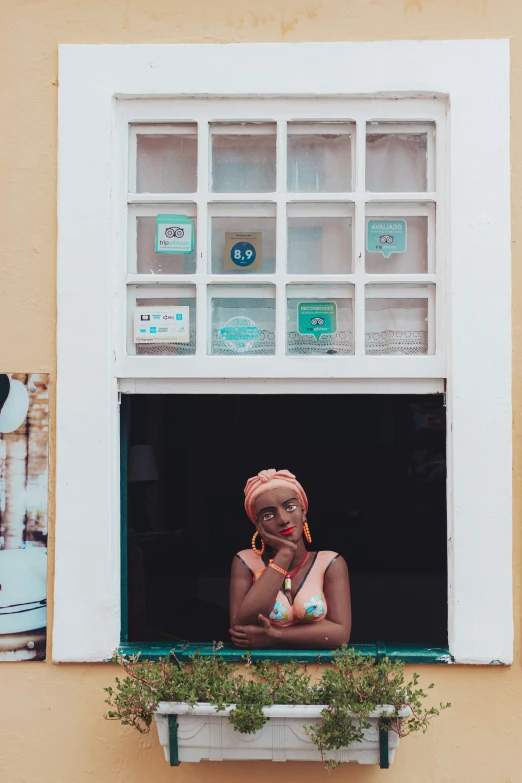 a woman with red hair is seen through the window of her house