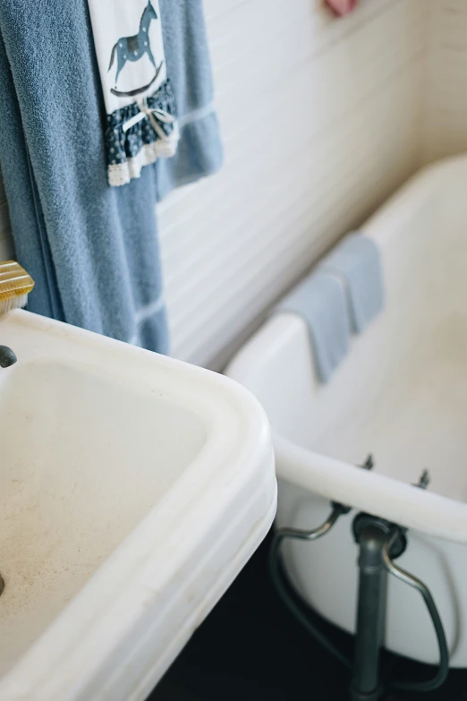 a bathroom with a white bath tub and a sink