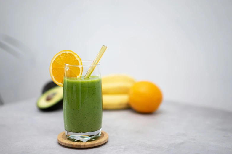 a s of a kiwi green smoothie with two oranges and a banana